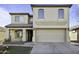 Two story home featuring neutral stucco, a tile roof and attached two car garage at 4552 S 238Th Ln, Buckeye, AZ 85326