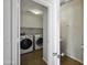 An open doorway showcases the laundry room, complete with modern Samsung appliances at 4552 S 238Th Ln, Buckeye, AZ 85326