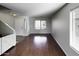Open and airy living area with hardwood floors and lots of natural light at 4552 S 238Th Ln, Buckeye, AZ 85326