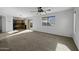 Open floor plan showcases living room, carpet, and kitchen with natural lighting at 4552 S 238Th Ln, Buckeye, AZ 85326