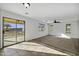 Living room with sliding glass door to backyard, neutral walls, and a ceiling fan at 4552 S 238Th Ln, Buckeye, AZ 85326