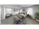 A spacious main bedroom features a king bed, neutral decor, and abundant natural light at 4552 S 238Th Ln, Buckeye, AZ 85326