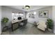 Bright home office with a modern desk, chair, and natural light from a large window at 4552 S 238Th Ln, Buckeye, AZ 85326