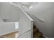 View of staircase with a wooden railing and carpeted steps at 4552 S 238Th Ln, Buckeye, AZ 85326