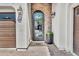 Elegant front entry featuring an ornate iron door, brick accents, and stylish lighting at 4639 N 29Th St, Phoenix, AZ 85016