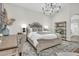 Relaxing bedroom features a king-size bed, a chandelier, a desk, and a comfortable sitting area at 4639 N 29Th St, Phoenix, AZ 85016