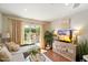Bright living room features hardwood floors, a cozy couch, and sliding glass doors at 4800 N 68Th St # 263, Scottsdale, AZ 85251