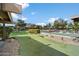 Community putting green and pool area with beautiful landscaping and mountain views on a sunny day at 4800 N 68Th St # 263, Scottsdale, AZ 85251