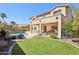 Beautiful backyard featuring a pool, covered patio, and well-manicured lawn for outdoor enjoyment at 4979 E Colonial Dr, Chandler, AZ 85249