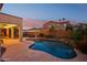 Backyard with a sparkling pool offering a perfect setting for evening relaxation and outdoor entertaining at 4979 E Colonial Dr, Chandler, AZ 85249