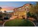 Beautiful backyard with a pool, grassy area, covered patio, and lush landscaping at 4979 E Colonial Dr, Chandler, AZ 85249