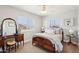 Charming bedroom featuring a vintage vanity, dresser, two windows with blinds, carpet flooring, and a decorative ceiling fan at 4979 E Colonial Dr, Chandler, AZ 85249