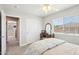 Cozy bedroom with a vintage vanity, window with blinds, carpet flooring, and a decorative ceiling fan to enhance its appeal at 4979 E Colonial Dr, Chandler, AZ 85249