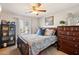 Cozy bedroom with comfortable bed, side table, ceiling fan and view to the outside at 4979 E Colonial Dr, Chandler, AZ 85249