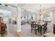 Bright open-concept dining room featuring a decorative chandelier and adjacent living space at 4979 E Colonial Dr, Chandler, AZ 85249