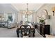 Formal dining room with a chandelier, large table, and traditional decor at 4979 E Colonial Dr, Chandler, AZ 85249