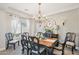 Elegant dining room featuring a chandelier and a large dining table at 4979 E Colonial Dr, Chandler, AZ 85249