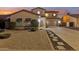 Charming home featuring xeriscaped yard and inviting curb appeal, complete with covered porch entrance at 4979 E Colonial Dr, Chandler, AZ 85249