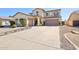 Expansive home boasts a three-car garage and covered porch, perfect for Gathering living at 4979 E Colonial Dr, Chandler, AZ 85249
