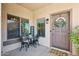 Inviting front porch with welcome sign, seating, and a decorative wreath on the front door at 4979 E Colonial Dr, Chandler, AZ 85249