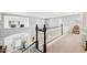 Open hallway with white railings showcasing views of the lower level and natural light at 4979 E Colonial Dr, Chandler, AZ 85249