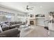 Spacious living room features a ceiling fan, fireplace, and large couch at 4979 E Colonial Dr, Chandler, AZ 85249