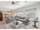 Comfortable living room open to the kitchen with a large grey sectional at 4979 E Colonial Dr, Chandler, AZ 85249