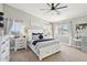 Comfortable main bedroom with a ceiling fan, two windows, and a stylish bed with decorative pillows at 4979 E Colonial Dr, Chandler, AZ 85249