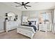 Bright main bedroom featuring a decorative mirror, white dresser, and a comfortable bed at 4979 E Colonial Dr, Chandler, AZ 85249