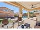 Covered patio with outdoor seating area, perfect for enjoying views of the landscaped backyard and pool at 4979 E Colonial Dr, Chandler, AZ 85249