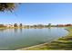 Picturesque lake view with homes in the distance, perfect for enjoying nature at 4979 E Colonial Dr, Chandler, AZ 85249
