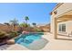 Lush backyard featuring a stunning pool with rock accents and vibrant landscaping creating a private oasis at 4979 E Colonial Dr, Chandler, AZ 85249