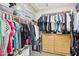 Organized walk-in closet features shelving, hanging racks, storage containers, and wooden drawers for optimal storage space at 4979 E Colonial Dr, Chandler, AZ 85249