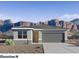 Beautiful single-story home with neutral tones, two-car garage, desert landscaping and mountain views at 5005 S 106Th Ave, Tolleson, AZ 85353