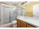 Clean bathroom featuring a tiled shower with glass doors and a vanity sink at 5200 S Lakeshore Dr # 106, Tempe, AZ 85283