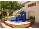 Beautiful courtyard fountain with brick and blue tile accents, surrounded by lush greenery at 5200 S Lakeshore Dr # 106, Tempe, AZ 85283
