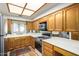 Functional kitchen featuring wood cabinetry, stainless steel appliances, and tiled flooring at 5200 S Lakeshore Dr # 106, Tempe, AZ 85283