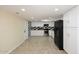 Modern kitchen featuring white cabinetry, black appliances, and tile flooring at 5202 N 40Th Dr, Phoenix, AZ 85019