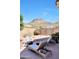Backyard oasis with desert landscaping, stone patio, seating and mountain views at 6408 W Prickly Pear Trl, Phoenix, AZ 85083