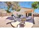 Charming backyard featuring desert landscaping, covered patio, and stylish outdoor furniture at 6408 W Prickly Pear Trl, Phoenix, AZ 85083