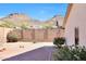 Spacious backyard with desert landscaping and mature bushes with mountain views in the distance at 6408 W Prickly Pear Trl, Phoenix, AZ 85083