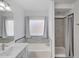 Bright bathroom with a bathtub and tiled shower at 6408 W Prickly Pear Trl, Phoenix, AZ 85083