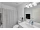 Bright bathroom featuring a striped shower curtain and a sink with ample counter space at 6408 W Prickly Pear Trl, Phoenix, AZ 85083