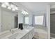 Bright bathroom featuring a dual sink vanity, bathtub, and natural lighting at 6408 W Prickly Pear Trl, Phoenix, AZ 85083