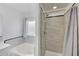 Bathroom with a tub and tiled shower at 6408 W Prickly Pear Trl, Phoenix, AZ 85083