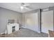 Bedroom featuring gray walls, ceiling fan, and a vanity with lighted mirror at 6408 W Prickly Pear Trl, Phoenix, AZ 85083
