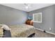 Bedroom featuring light gray walls, ceiling fan, and a mounted television at 6408 W Prickly Pear Trl, Phoenix, AZ 85083