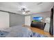 Bedroom with hardwood floors, sliding barn door, and a mounted television at 6408 W Prickly Pear Trl, Phoenix, AZ 85083