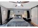 Bedroom featuring barn door, ceiling fan, and decor on wall at 6408 W Prickly Pear Trl, Phoenix, AZ 85083