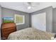 Bedroom featuring light gray walls, ceiling fan, and a mounted television at 6408 W Prickly Pear Trl, Phoenix, AZ 85083